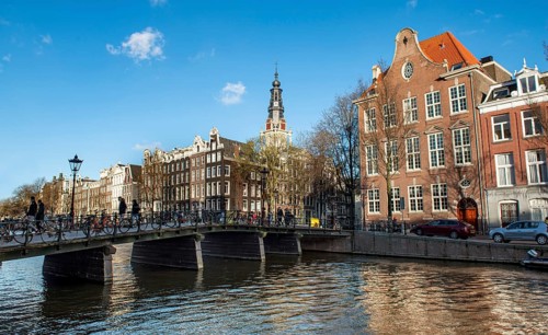 Bridge and historic houses at the Kloveniersburgwal with Zuiderkerk