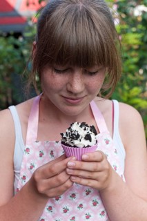Girl looking at a homemade Oreo brownie cupcake