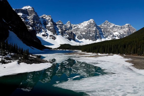 Wenkchemna Peaks mountain group reflected in the glacial Moraine Lake