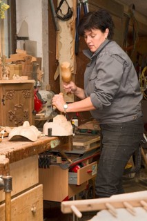 Young farmer carving traditional masks