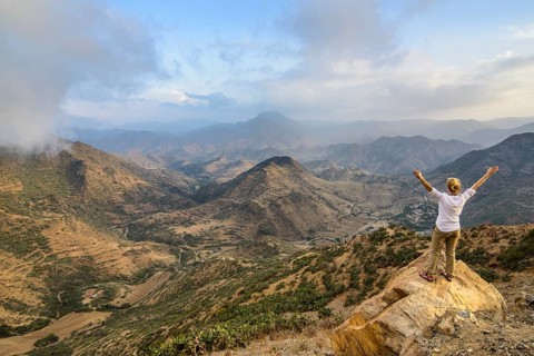 Woman enjoying the view over the mountains along the road from Massawa to Asmarra