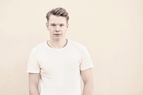 Portrait of young man in front of wall