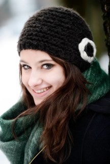 Smiling young woman wearing hat and scarf in winter
