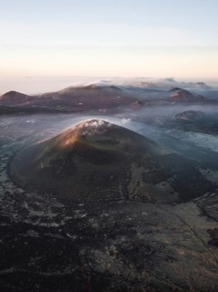 Volcanic crater with clouds