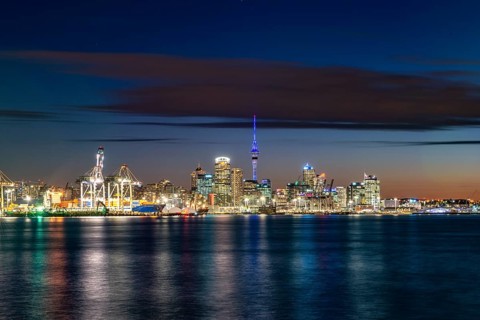 Illuminated skyline of Auckland at sunset