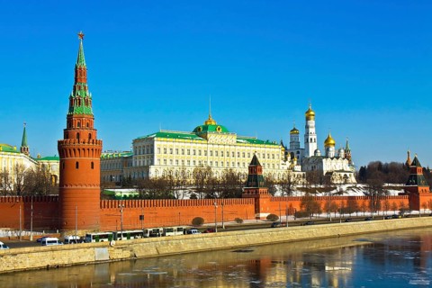 Moscow Kremlin with palace and cathedrals on bank of Moskva River with reflections