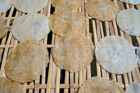 Rice cakes drying on a bamboo frame
