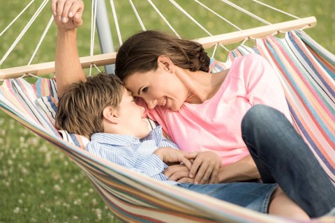 Mother and son lying in hammock