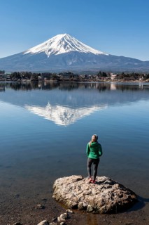 Young woman standing on stone in water