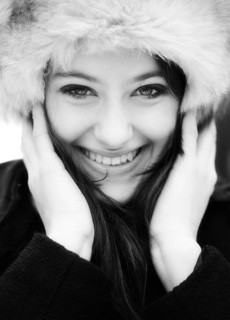 Smiling young woman wearing a fur hat