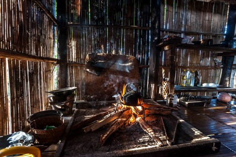 Kettle over an open fire in a kitchen made of bamboo