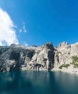Mountain lake Lac de Melo surrounded by cliffs