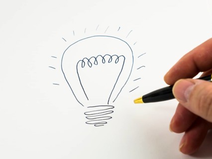 Hand drawing a light bulb