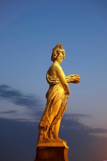 Seasons statue on Ponte Santa Trinita bridge spanning the river Arno