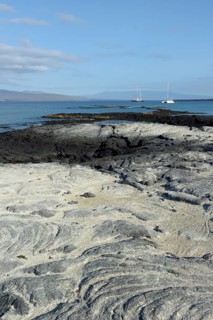 Sailboats anchored off the rocks at Punta Espinosa