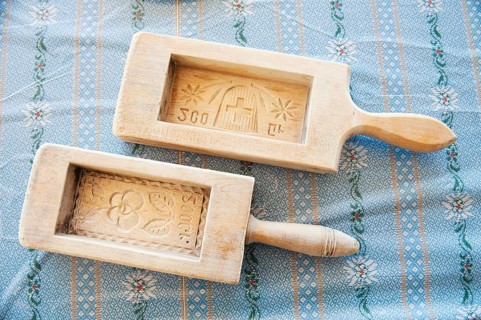 Two wooden butter moulds with carvings
