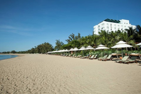 Beach with sun beds of the Saigon Ninh Chu Resort on the beach of Phan Rang