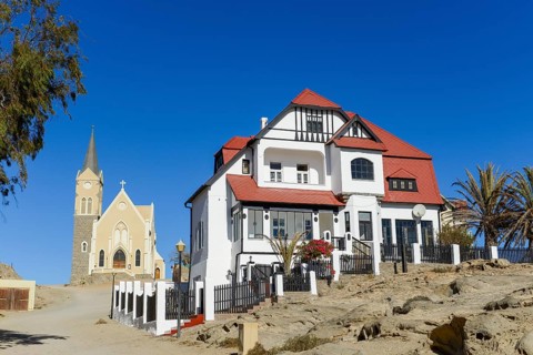 Half-timbered house from German colonial times and rock church in the old town of Luderitz