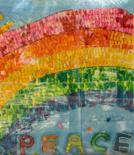 Origami cranes folded by children write Peace
