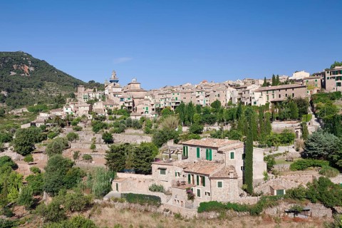 Townscape with Valldemossa Charterhouse and parish church of Sant Bartomeu