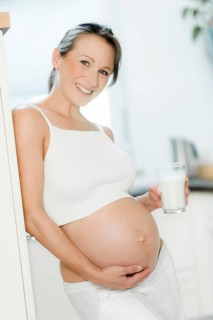 Pregnant woman holding a glass of milk