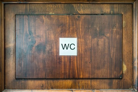 Toilet sign on a wooden door