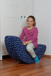 Girl on a child's rocking chair
