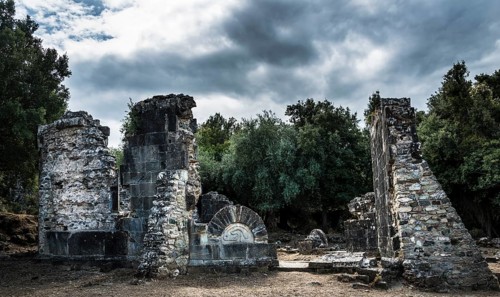 Ruins of the church of Santa Maria di Riscamone against a dramatic sky