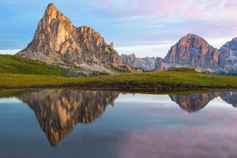 Gusela mountain at sunrise reflected in small lake