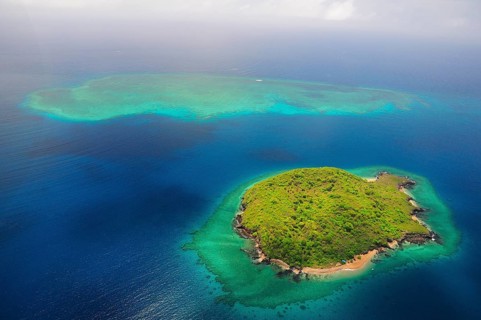Uninhabited island with coral reef