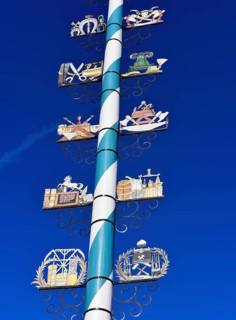 Maypole with wooden signs of local trades