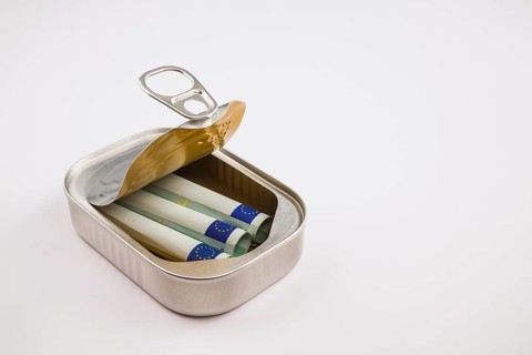 Three rolled-up 100 Euro banknotes inside a silver aluminum can on white background