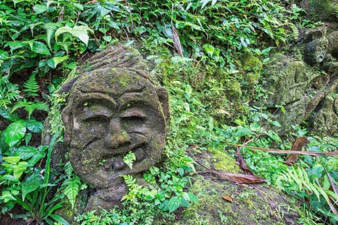 Moss-covered sculpture in the forest