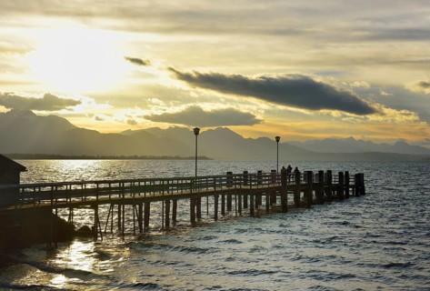 Boathouse with jetty at sunset on Lake Chiemsee