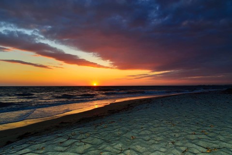 Sunset at sea with cloudy sky