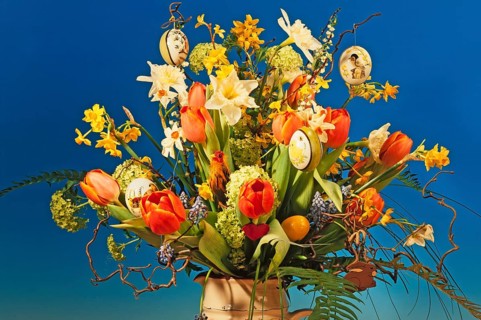 Easter bouquet in a vase against blue