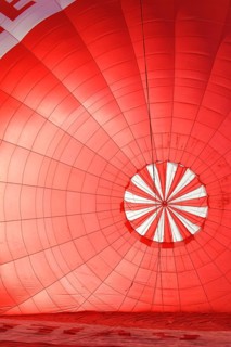 A red hot air balloon being inflated