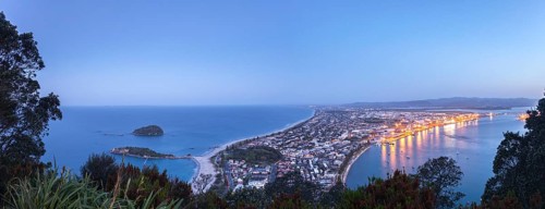Panoramic view of the town of Mount Maunganui and the Port of Tauranga at nightfall