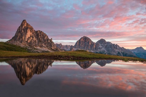 Gusela mountain at sunrise reflected in small lake