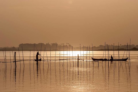 Fishermen in boats in the evening light