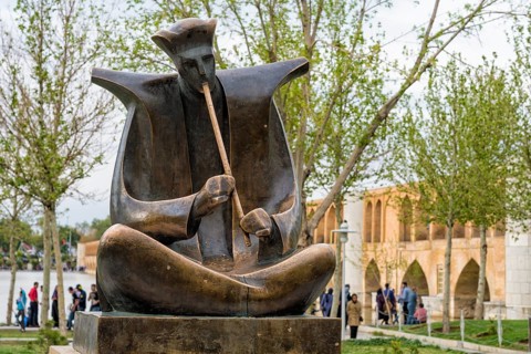 Musician sculpture on the Zayande-Rud riverbank at Si-o-se Pol Bridge or Allah-Verdi Khan Bridge