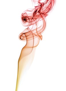 Colourful smoke from an incense stick or joss stick