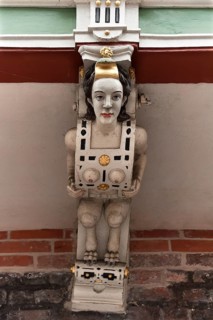 Carved female figure on the wooden balcony of the historic Town Hall