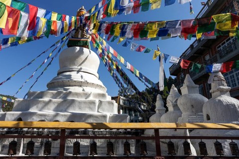 Stupa with prayer flags and prayer wheels