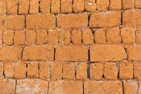 Clay brick wall with straw