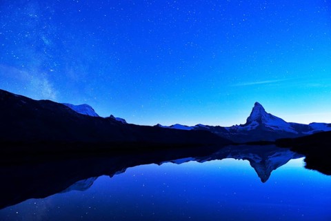 Matterhorn with Milky Way reflected in lake Stellisee