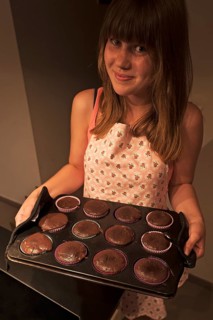 Girl presenting her homemade Oreo brownie cupcakes