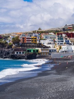 Tourists on the black beach of Puerto Naos