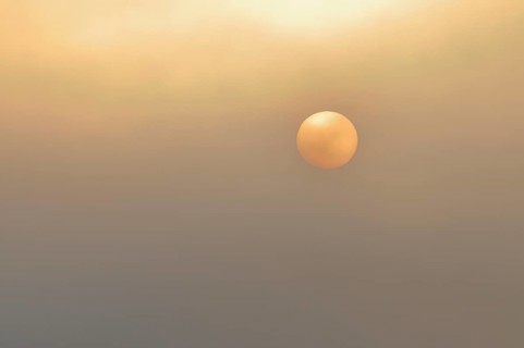Sun at sunrise with fog