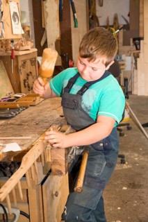 Farmer's son repairing a hay rake
